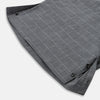 View 5 of product The Turnbull & Asser Charcoal Melange Check Hampstead overshirt, a long-sleeve button-up with a collar and two zippered side pockets, is laid flat on a light gray background.