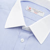 View 5 of product The Wall Street Shirt with White T&A Collar by Turnbull & Asser, as seen on Gordon Gekko, is folded neatly to showcase its light purple color, crisp French cuffs, and iconic contrasting collar against a plain background.