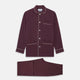 The Turnbull & Asser Plain Plum Silk Modern Pyjama Set, made in England, features white piping, a button-up long-sleeve top with three pockets, and matching pants. The pyjamas are shown against a white background.