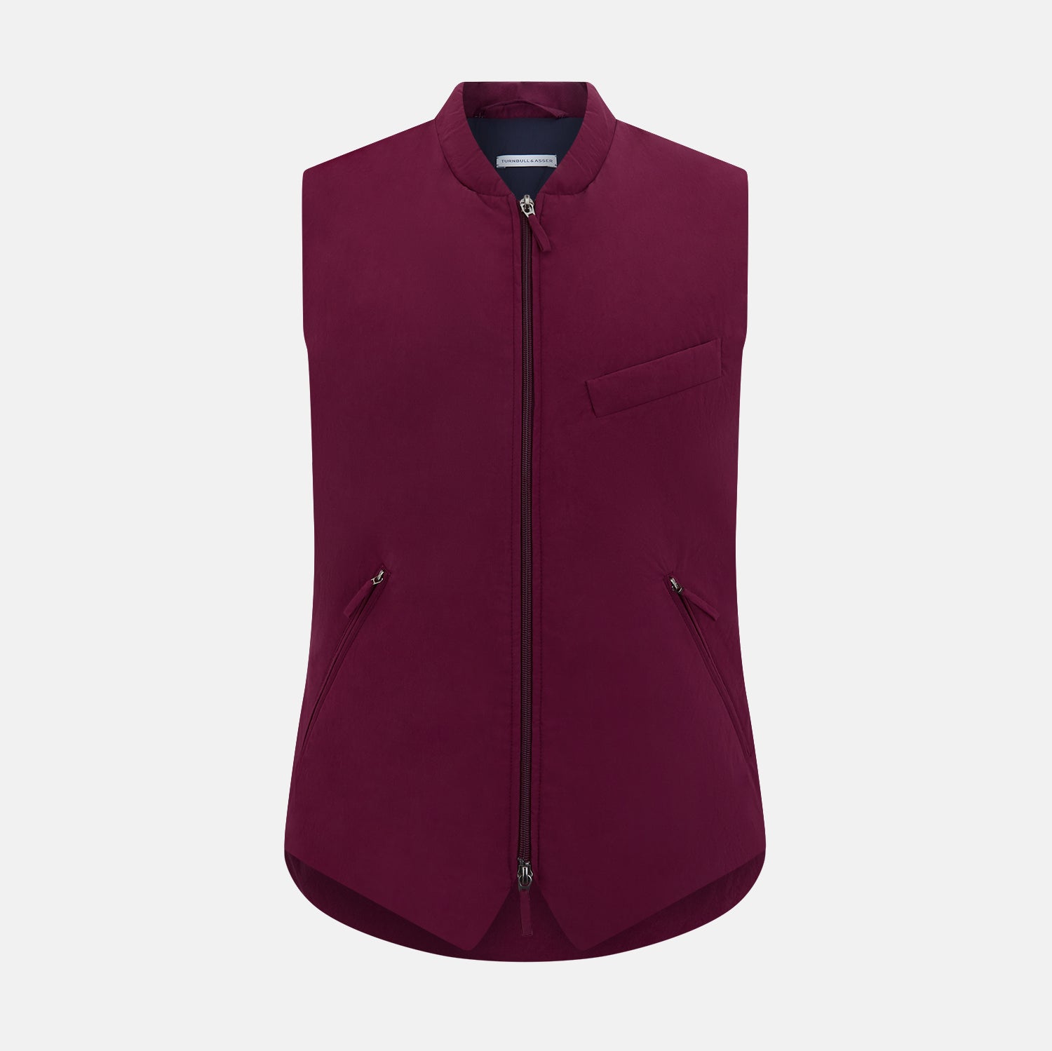 View 1 of product The Turnbull & Asser Wine Red Padded Gilet features a sleeveless design, front zipper, two zippered side pockets, a slanted chest pocket, and a rounded hem—perfect for the modern gentleman and shown on a plain white background.