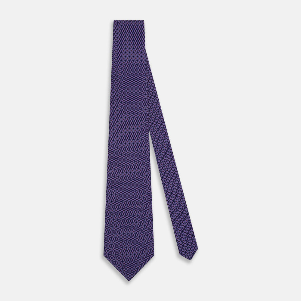 The Turnbull & Asser Purple Square and Circle Silk Tie is crafted from fine English silk, showcasing a purple design with a repeating geometric pattern of squares and circles for a refined, elegant look.