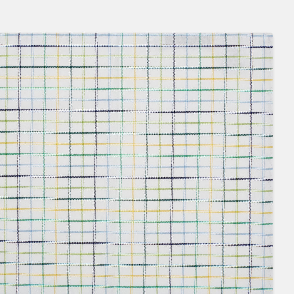 The Yellow Multi Double Grid Check Hand-Rolled Handkerchief by Turnbull & Asser is handcrafted in England, featuring a colorful check pattern with evenly spaced blue, green, yellow, and purple lines.