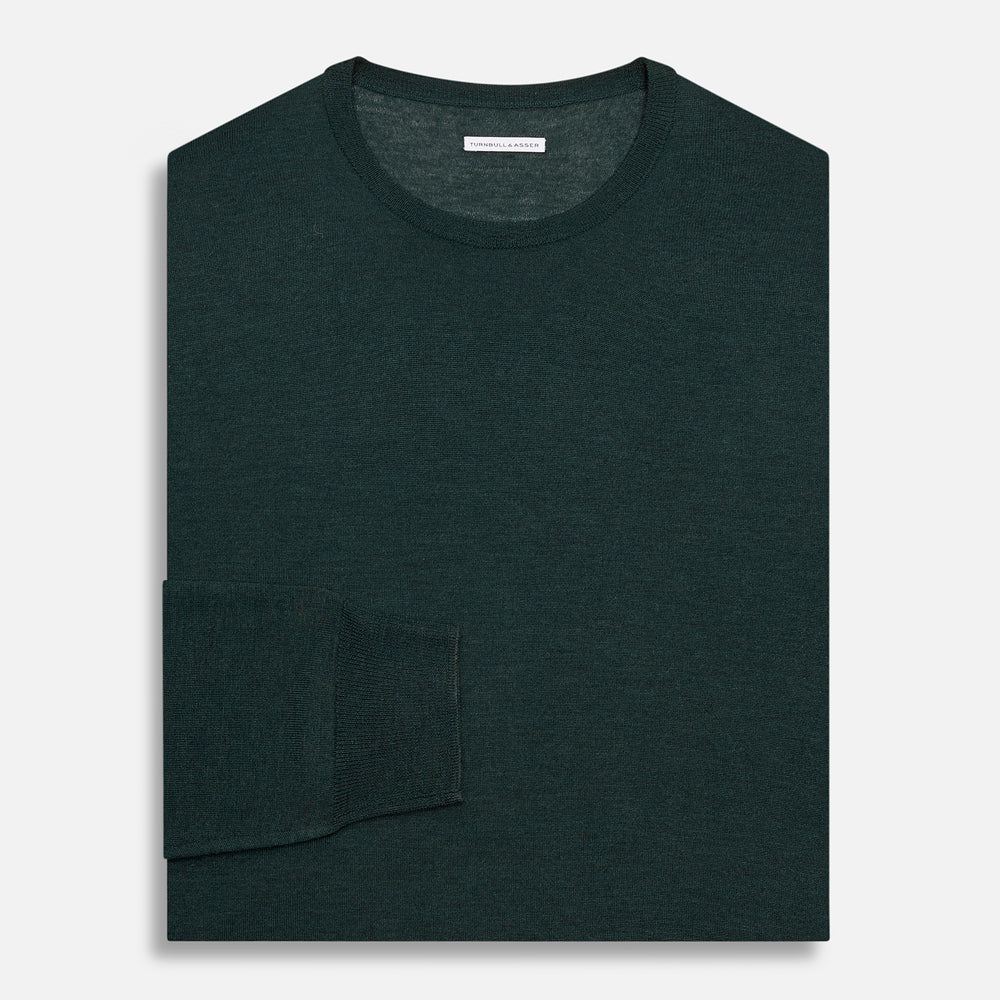 The Turnbull & Asser Forest Green Fine Merino Round Neck Jumper for men is shown on a light gray background. This knitwear features a classic design with ribbed cuffs, hem, and neckline.