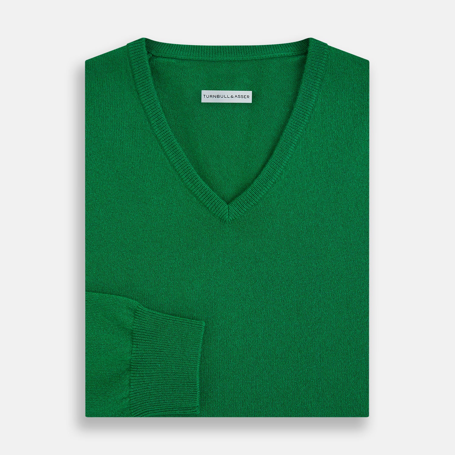 View 4 of product The Turnbull & Asser Grass Green Cashmere V-neck Jumper, with long sleeves, is displayed against a white background, highlighting its classic knitwear style.