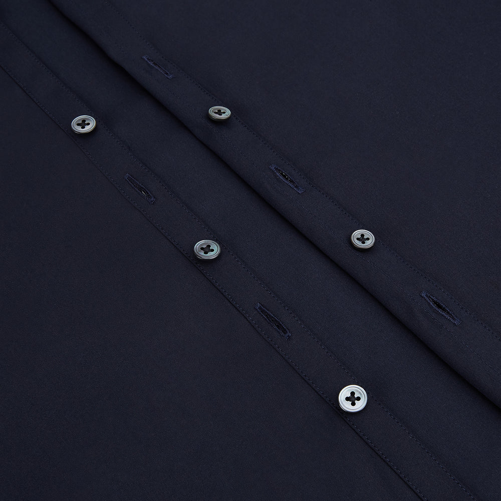 The Navy Westminster Shirt by Turnbull & Asser is a classic long-sleeve, button-up shirt with a pointed collar and buttoned cuffs, exemplifying British craftsmanship, shown against a plain white background.