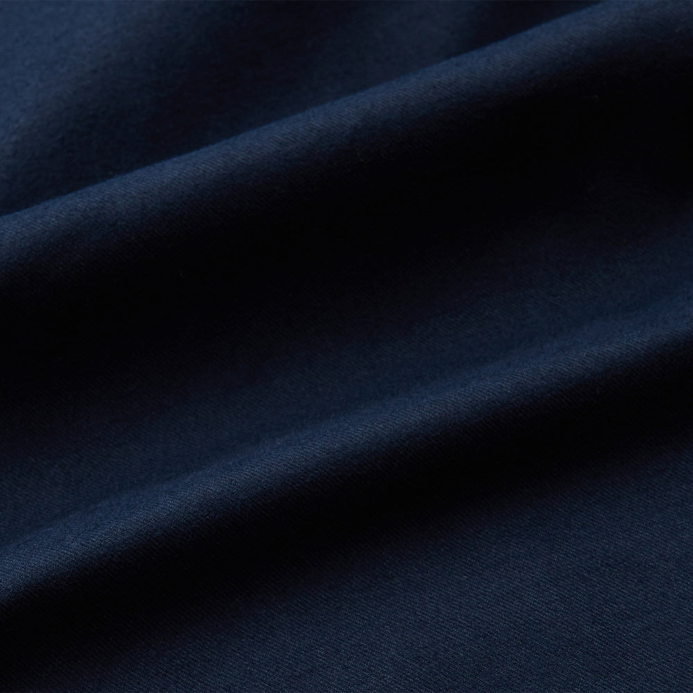 The Turnbull & Asser Navy Cotton Regular Fit Mayfair Shirt is a long-sleeved men’s formal shirt with a collar and white buttons, shown against a plain white background.
