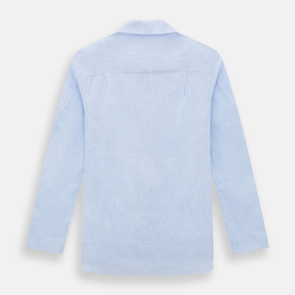The Turnbull & Asser Pale Blue Linen Pyjama Shirt features long sleeves, a collar, front buttons, and a chest pocket—perfect as elegant loungewear or nightwear.