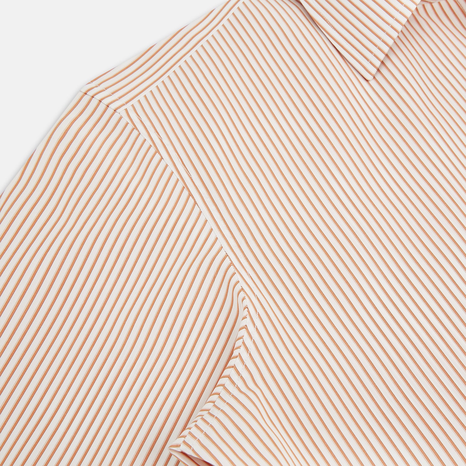 View 6 of product The Orange Multi Stripe Westminster Shirt by Turnbull & Asser features thin vertical orange and white stripes, a Turnbull collar, and long sleeves, elegantly displayed flat against a white background.
