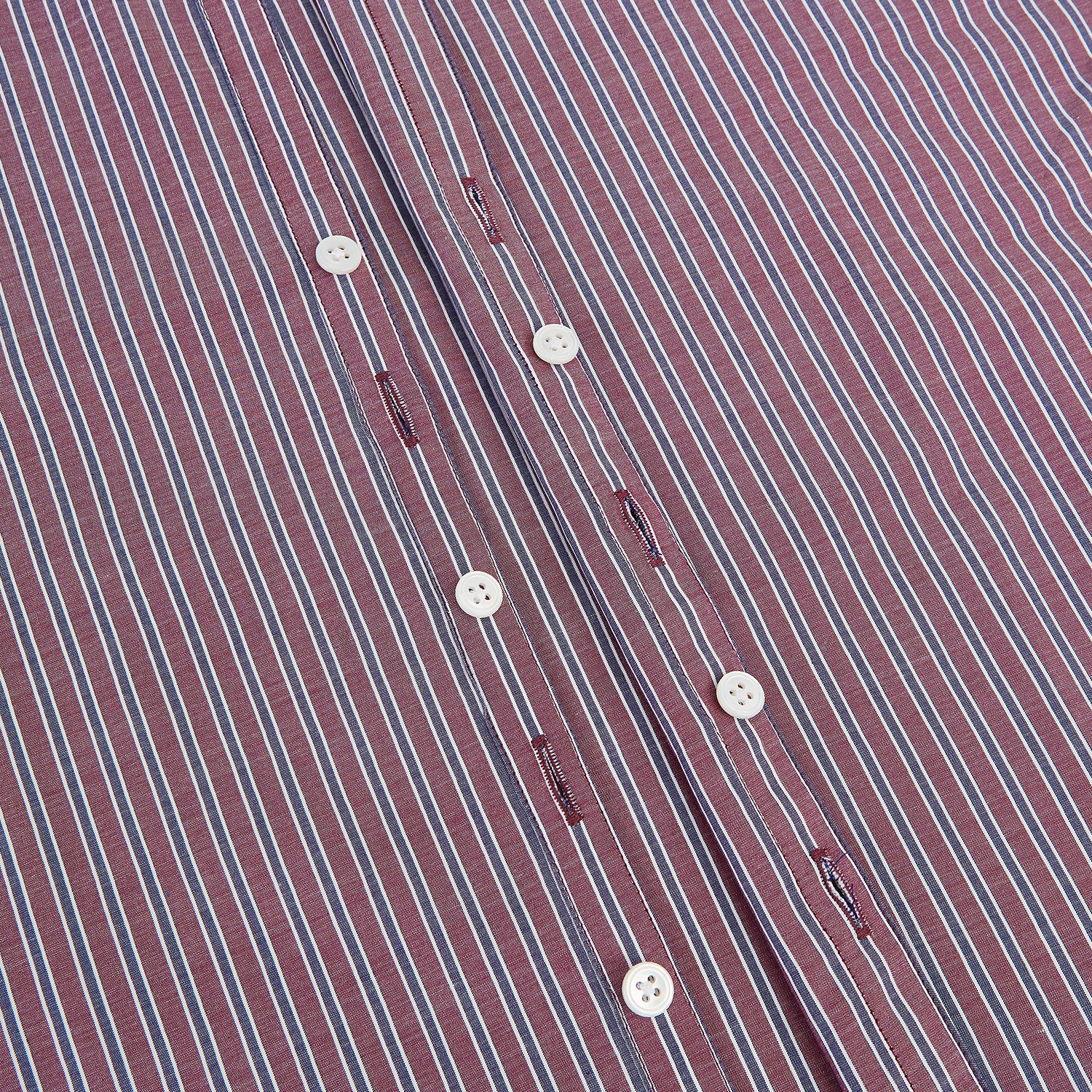 View 7 of product The Turnbull & Asser Wine Ticking Stripe Westminster Shirt features red, blue, and white vertical pinstripes on white and is shown laid flat on a white surface.