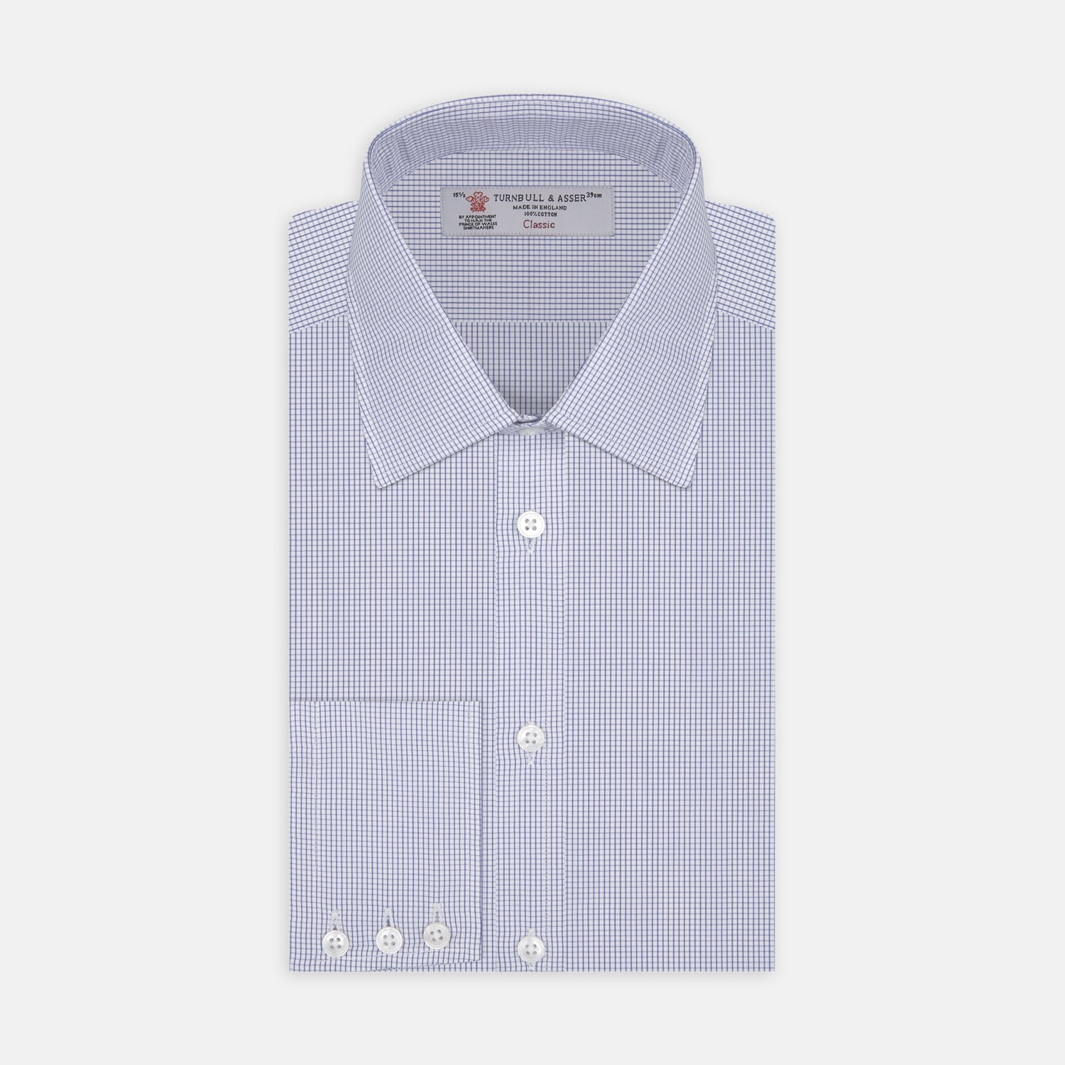 View 1 of product A neatly folded Turnbull & Asser Blue Grid Check Shirt features a T&A collar, 3-button cuffs, white buttons, and subtle British style. The blue and white check cotton design displays the brand label inside the collar.