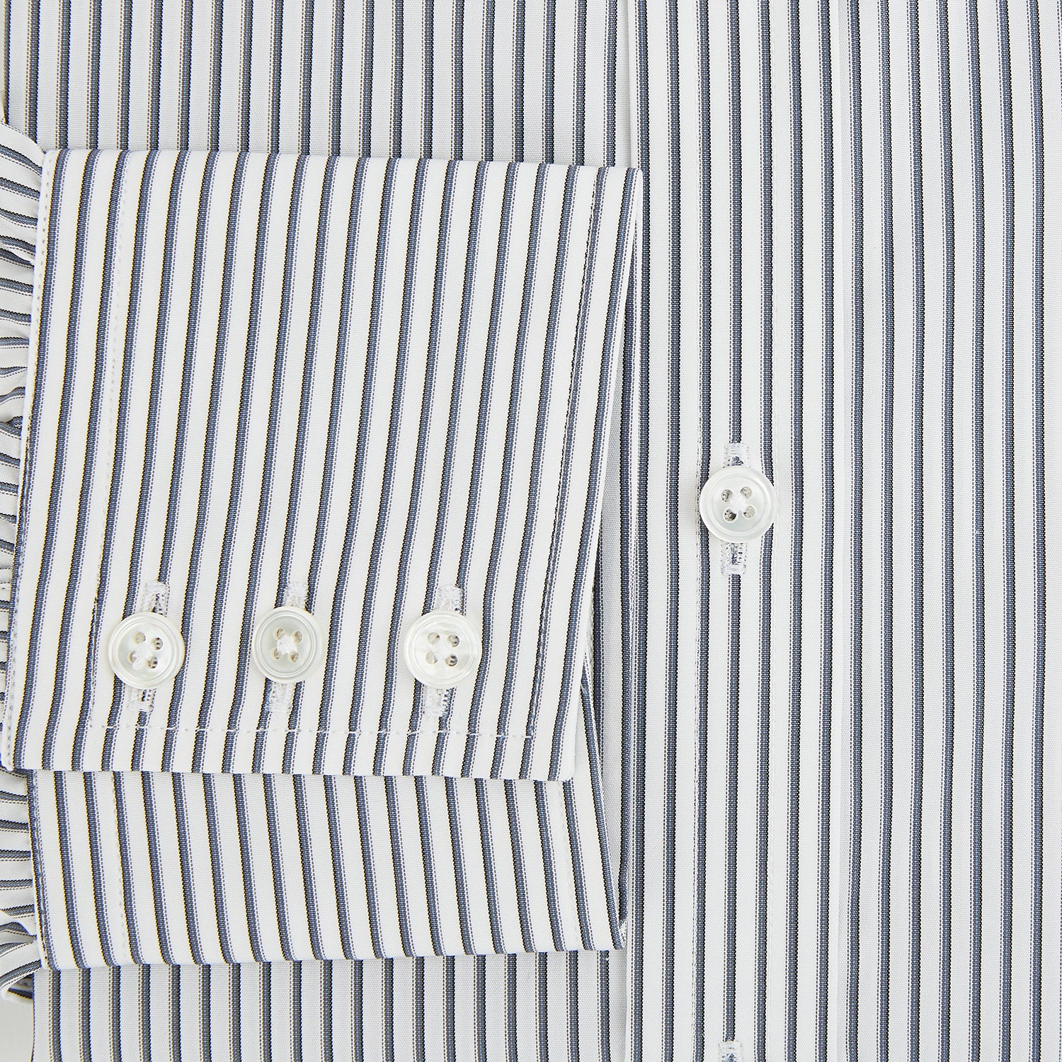 View 4 of product The Turnbull & Asser Grey Multi Stripe Mayfair Shirt features long sleeves, a classic collar, and thin vertical stripes in black and white, shown laid flat on a white background.