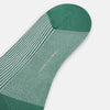 View 3 of product Turnbull & Asser Melon Green/White Thin Striped Long Sock features melon green and white vertical stripes with a solid green toe, heel, and cuff, shown singly against a plain light background.