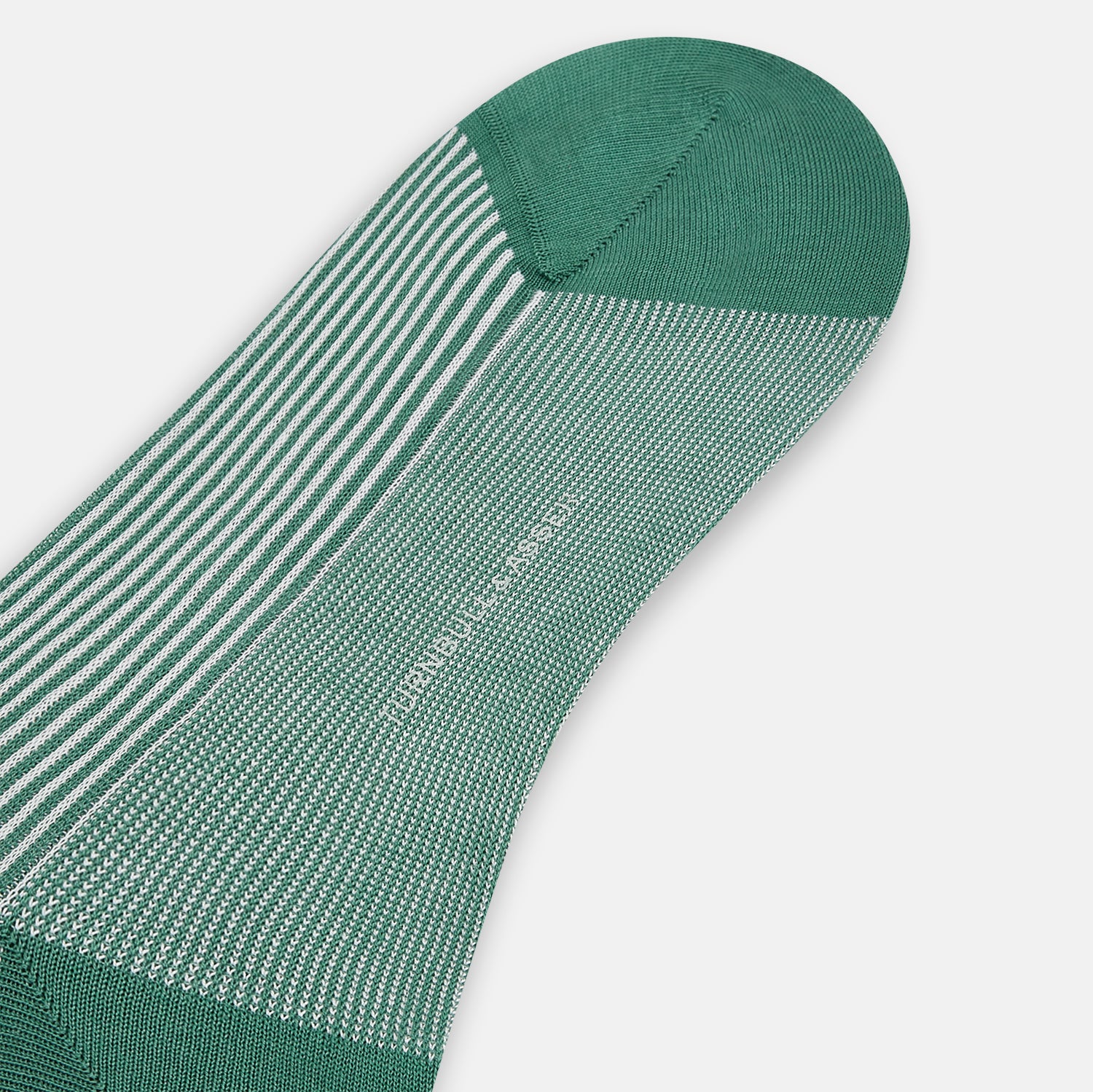 View 3 of product Turnbull & Asser Melon Green/White Thin Striped Long Sock features melon green and white vertical stripes with a solid green toe, heel, and cuff, shown singly against a plain light background.