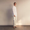 View 3 of product The White Cotton Lauren Shirt by Turnbull & Asser, featuring a stand collar, button-down front, and elongated body, is laid flat on a plain white background.