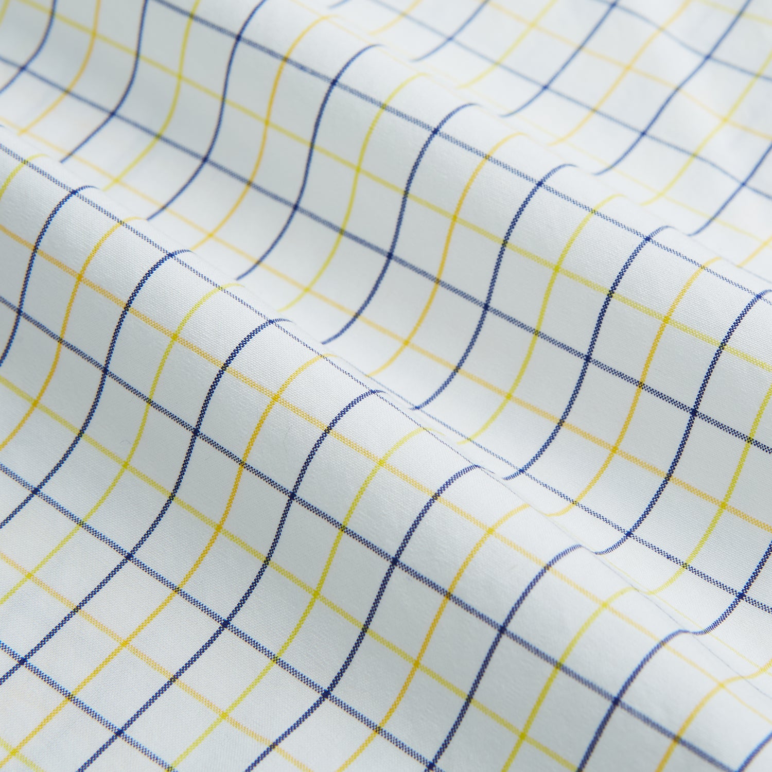 View 6 of product The Turnbull & Asser Yellow Overlay Grid Check Mayfair Shirt is a long-sleeve, button-down shirt made from soft organic cotton, featuring a yellow grid check pattern and shown laid flat on a white background.