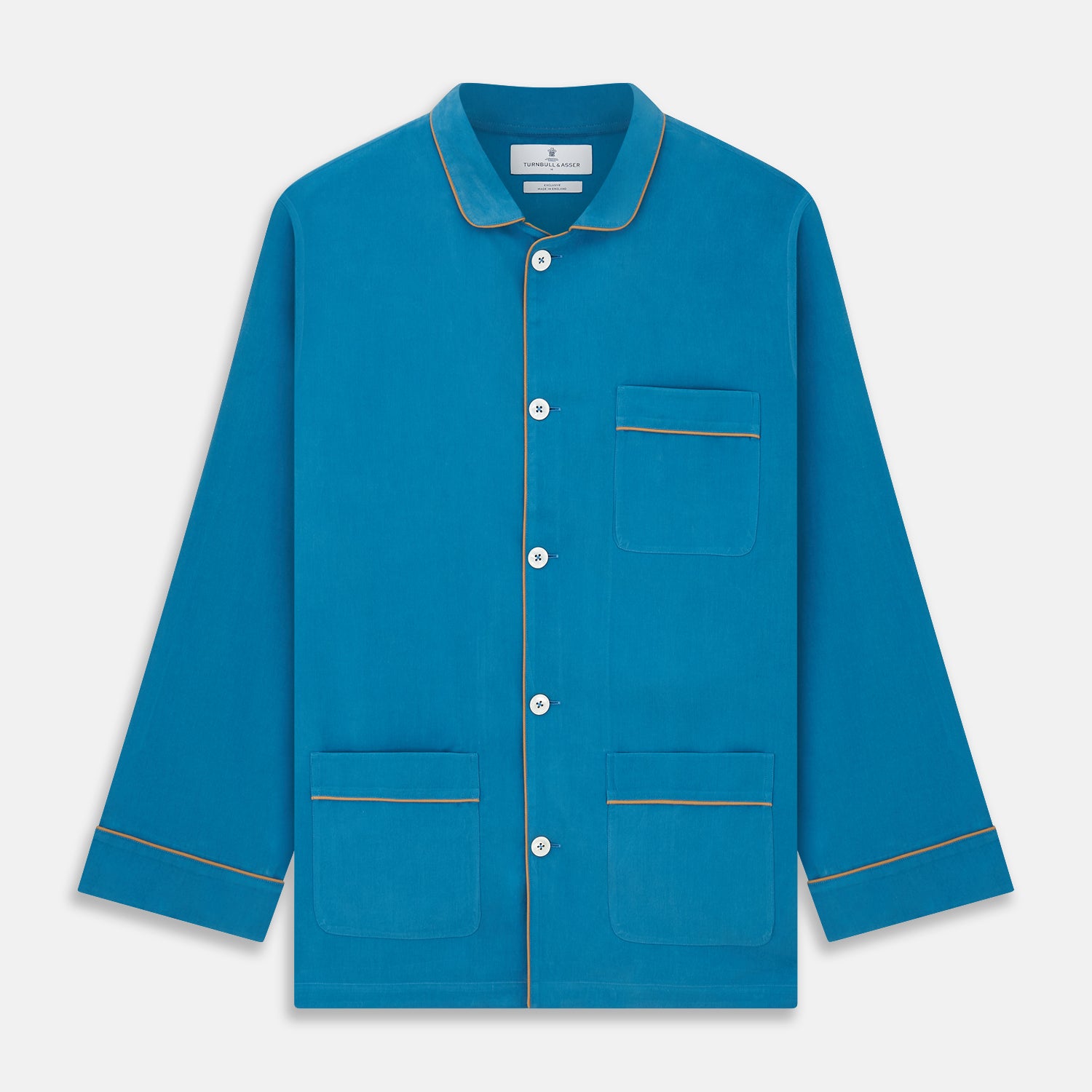View 6 of product The Turnbull & Asser Blue Silk Hyde Pyjama Set features a modern fit with a long-sleeve button-up top, three pockets, white trim, and elastic-waist pants, all shown on a white background.