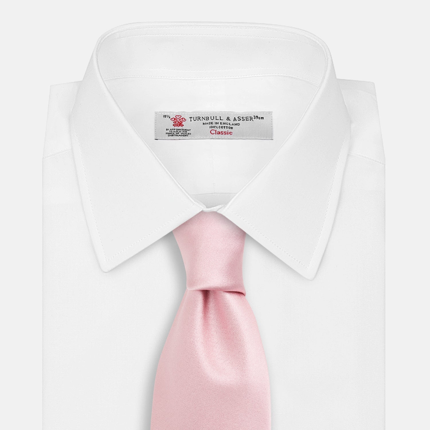 View 2 of product The Turnbull & Asser PINK PLAIN SATIN SILK TIE is neatly rolled and showcased against a plain white background.