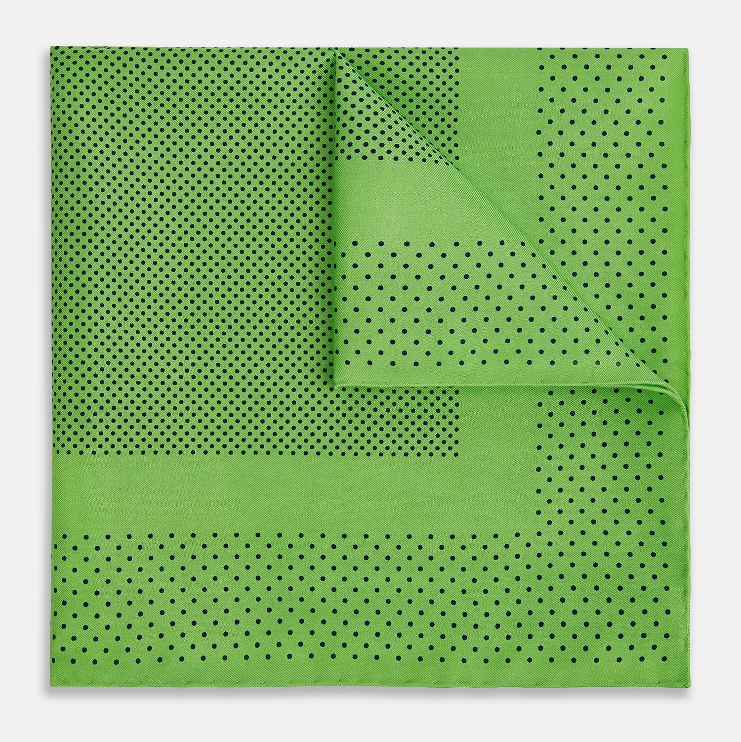 View 3 of product The Fern Green Dot Silk Pocket Square by Turnbull & Asser is crafted from pure silk, featuring a subtle black polka dot border with a denser dot pattern at the center and the brand name printed in the upper right corner.