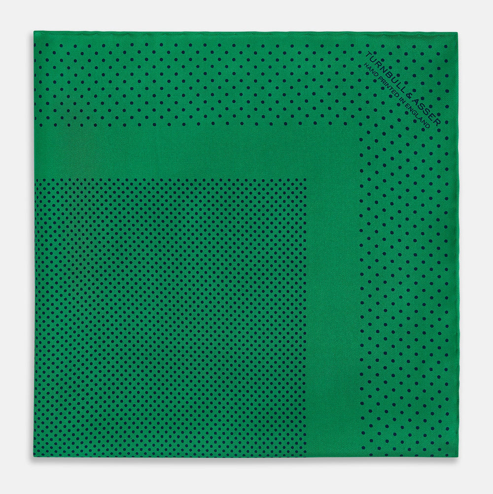 The Turnbull & Asser Green Dot Silk Pocket Square is handmade in England and shown neatly folded, revealing the front and part of the underside against a white background.