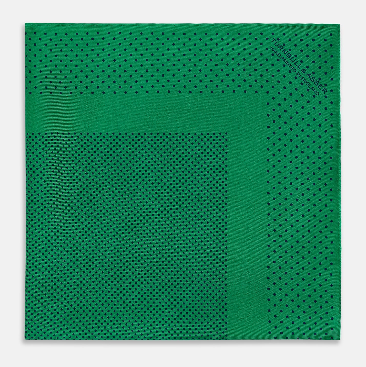 View 3 of product The Turnbull & Asser Green Dot Silk Pocket Square is handmade in England and shown neatly folded, revealing the front and part of the underside against a white background.