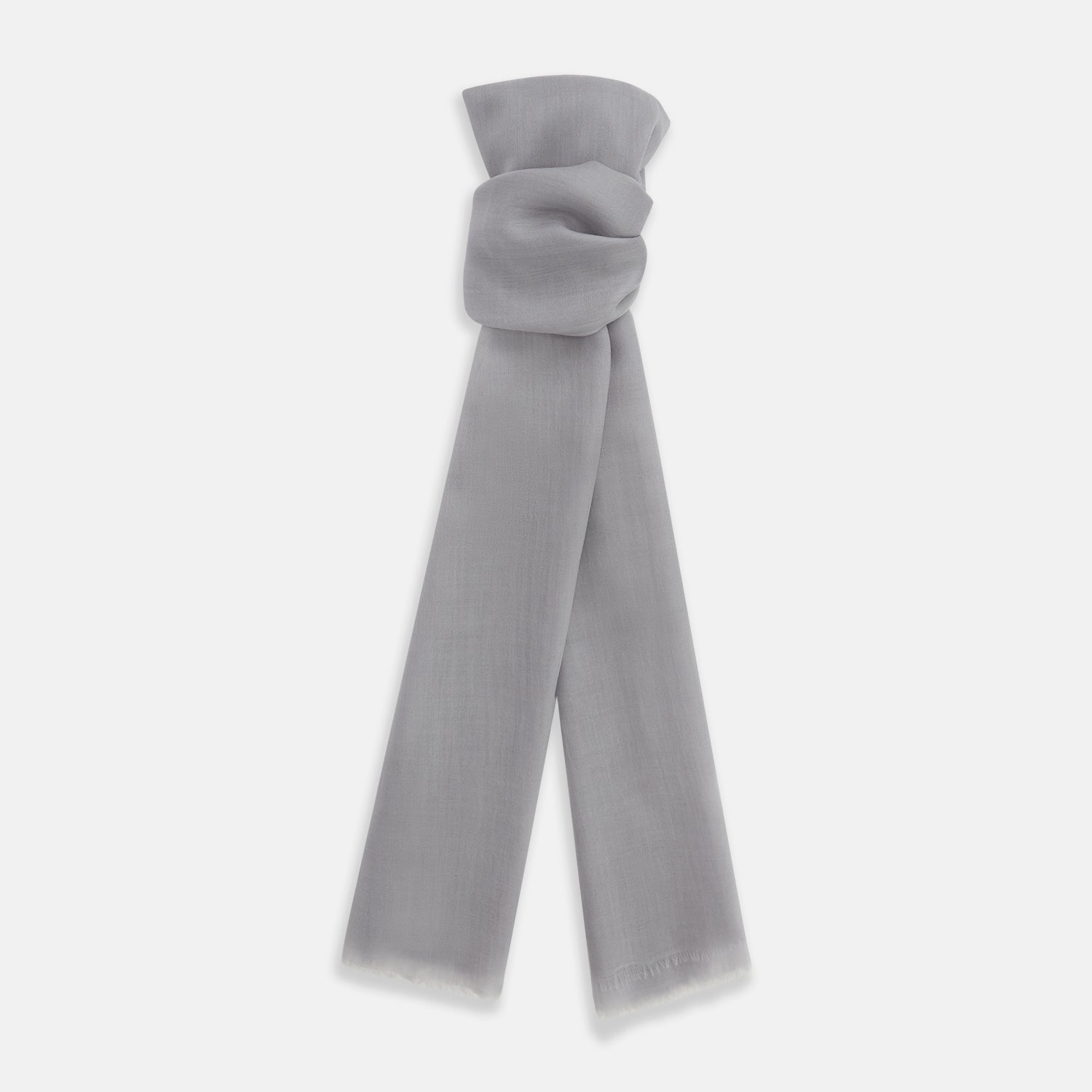 View 1 of product The Grey Cashmere Scarf by Turnbull & Asser, displayed folded with a loose knot on a white background, showcases semi-sheer luxury in light gray—an elegant accessory.