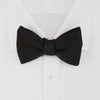 View 2 of product The Turnbull & Asser Black Herringbone Silk Bow Tie, ideal for formal occasions, features a subtle herringbone pattern and is shown against a plain white background.