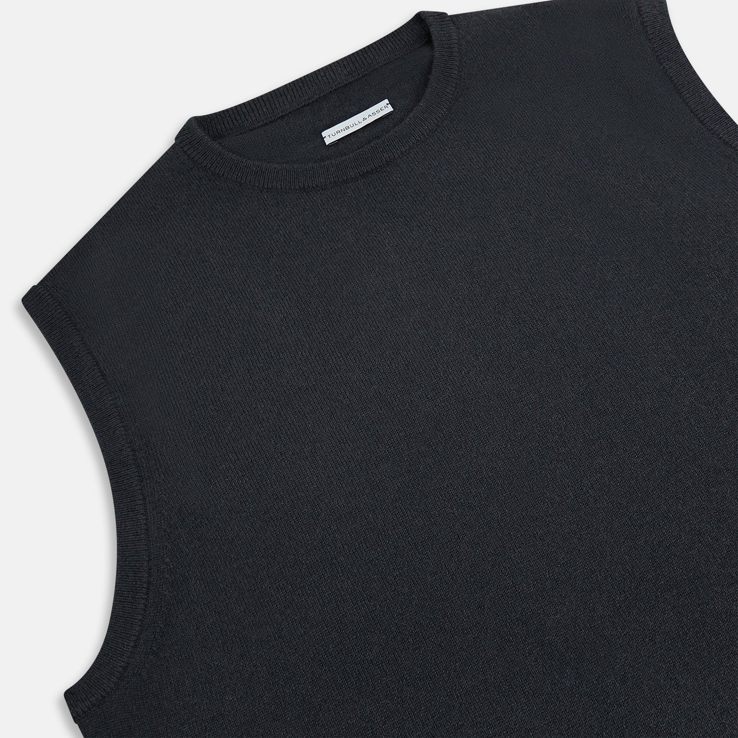 View 2 of product The Turnbull & Asser Dark Green Cashmere Round Neck Vest is a sleeveless knit style with a ribbed hem, shown against a white background—a modern, versatile twist on the classic vest.