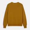 View 3 of product The Turnbull & Asser Gold Crew Neck Merino Jumper, featuring long sleeves and ribbed cuffs and hem, is displayed flat on a white background.