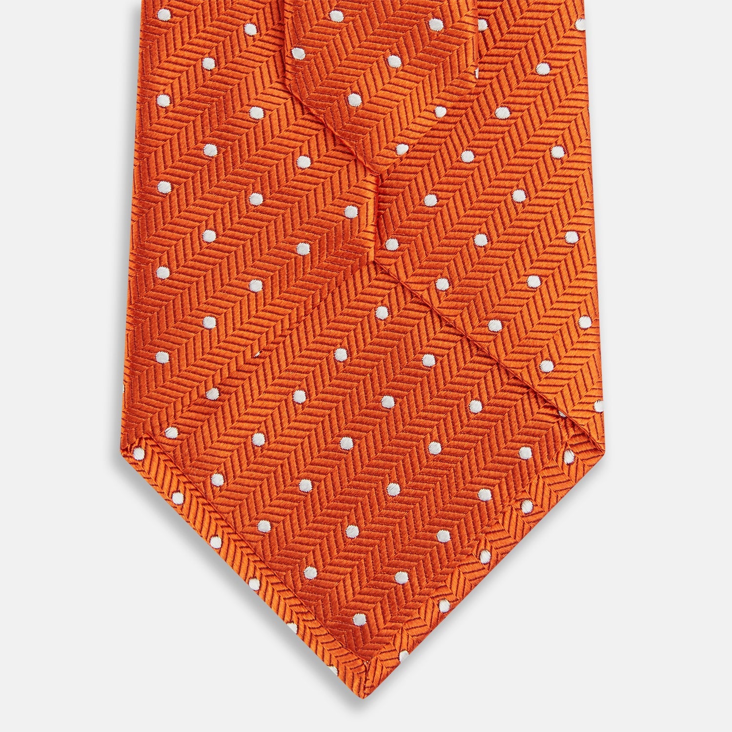 View 3 of product The Turnbull & Asser Orange and White Micro Dot Silk Tie features a subtle herringbone weave with small white dots—an elegant, modern accessory for the office.