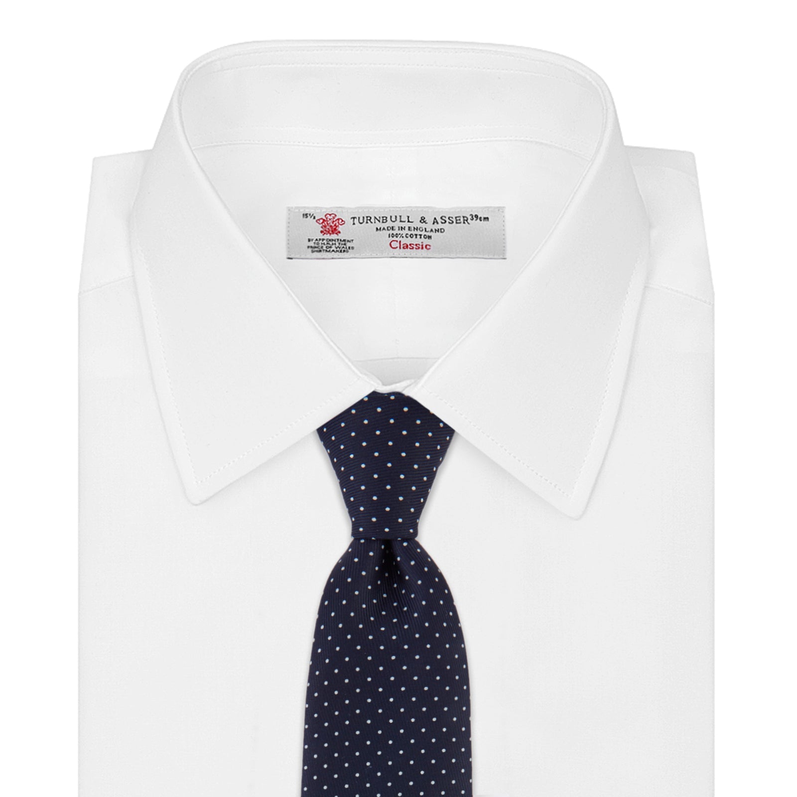 View 2 of product The Turnbull & Asser White and Navy Spot Printed Silk Tie, shown rolled with its pointed end forward on a white background, is an elegant accessory that pairs perfectly with a crisp shirt for smart occasions.