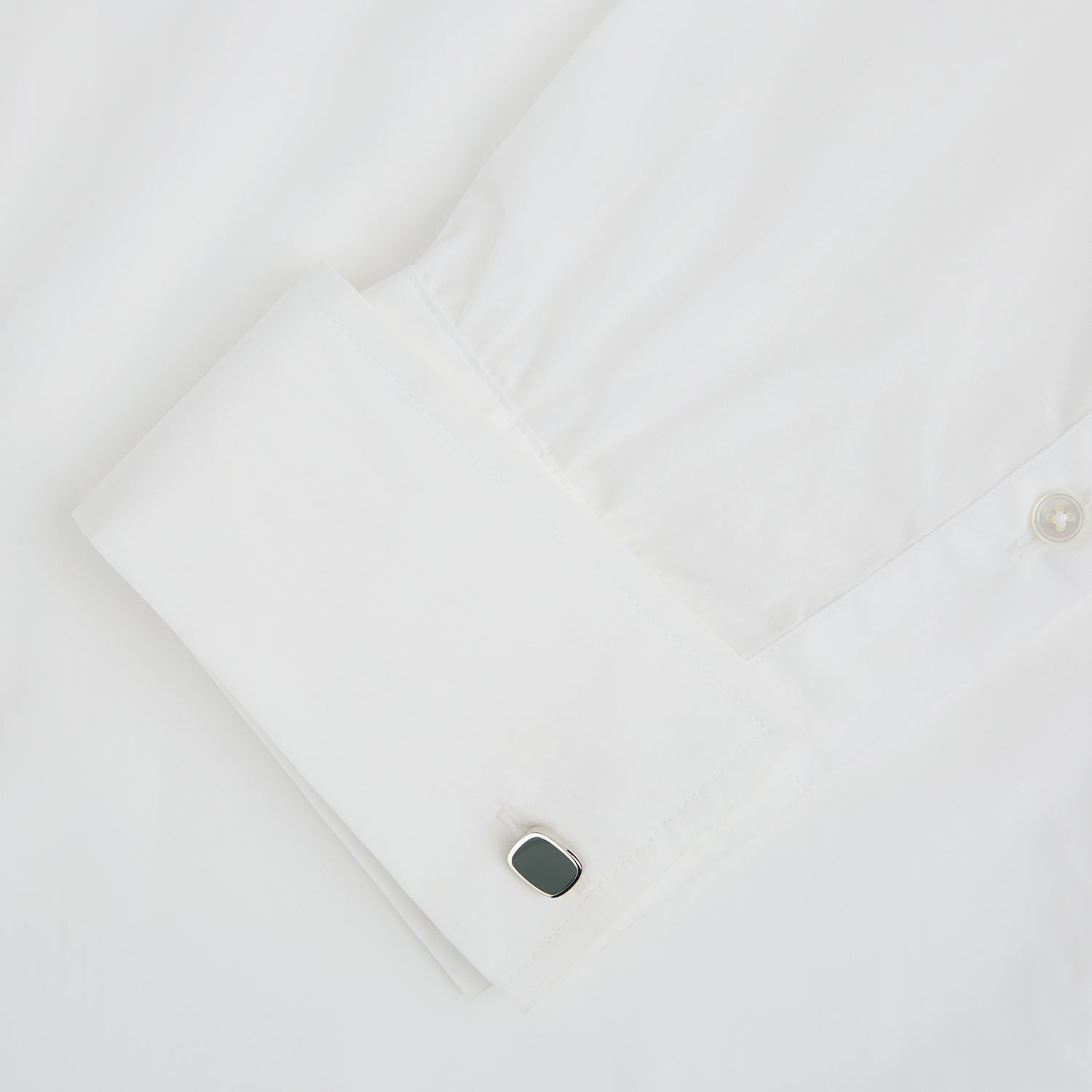 View 3 of product Turnbull & Asser's Green Rounded Square Cufflinks feature sterling silver and dark green faces—sophisticated formal accessories perfect for elevating any refined ensemble.