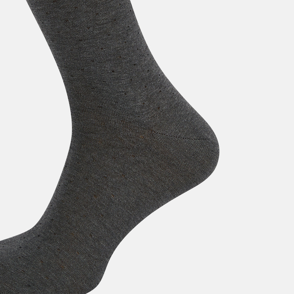 The Turnbull & Asser Steel/midnight Polka Dot Long Sock is shown in dark gray over the calf, displayed from the side on a white background with downward toe and ribbed top for a snug fit.