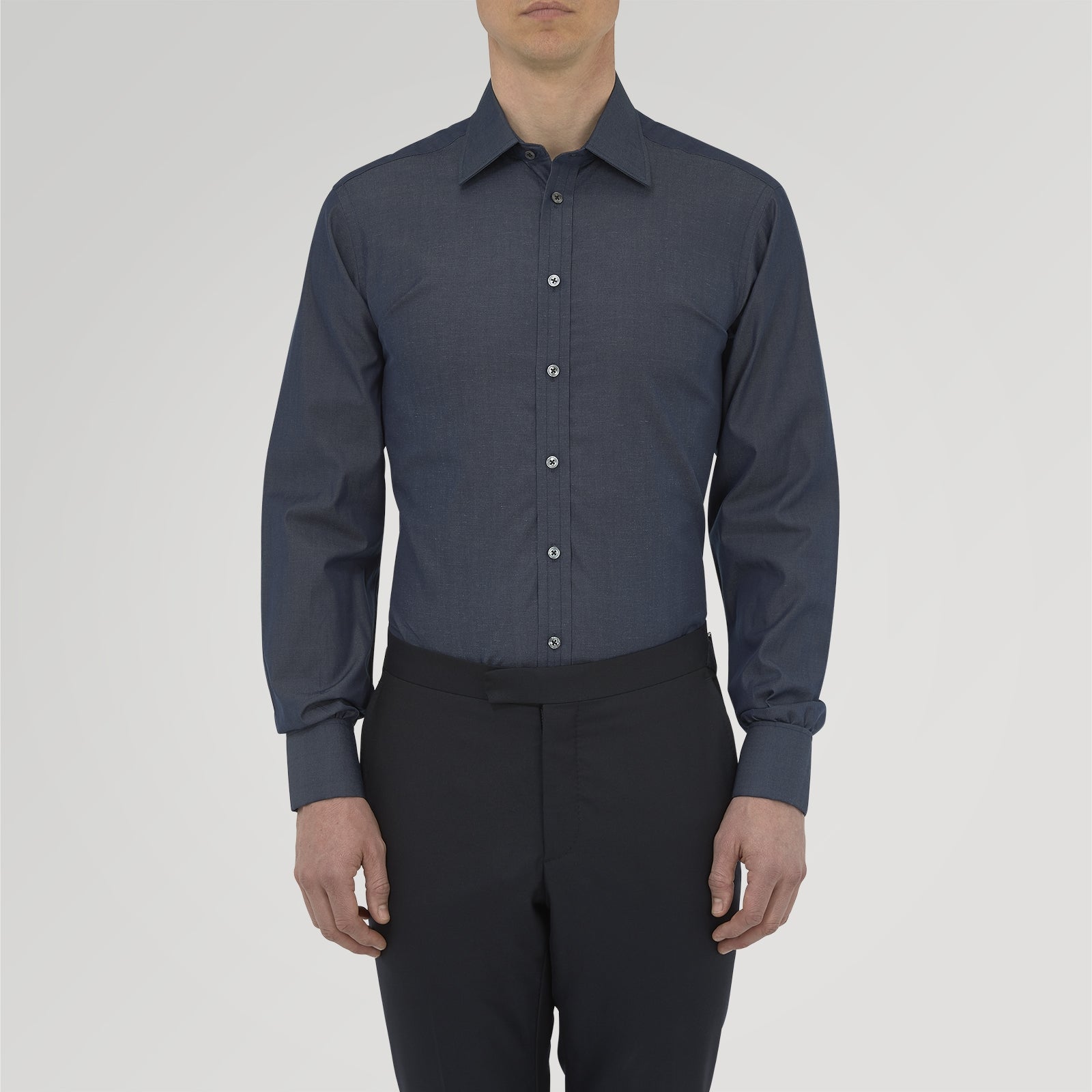 View 2 of product A neatly folded Turnbull & Asser Dark Blue Denim-Cashmere Shirt with a T&A collar and double cuffs, featuring black buttons, shown on a white background. The label inside the collar highlights its smart finish and refined style.