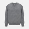 View 1 of product The Turnbull & Asser Grey Melange Cashmere V-neck Jumper features long sleeves, ribbed cuffs and hem, showcasing timeless style against a white background.