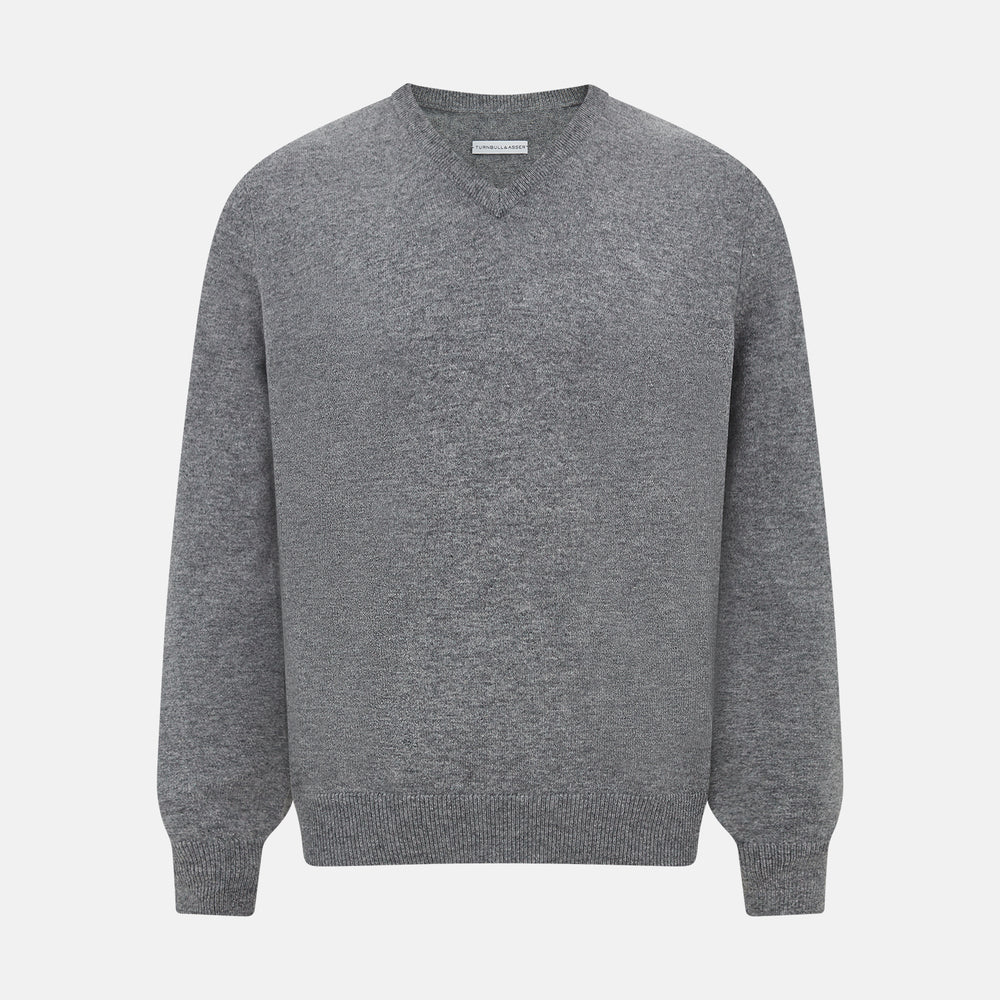 The Turnbull & Asser Grey Melange Cashmere V-neck Jumper features long sleeves, ribbed cuffs and hem, showcasing timeless style against a white background.