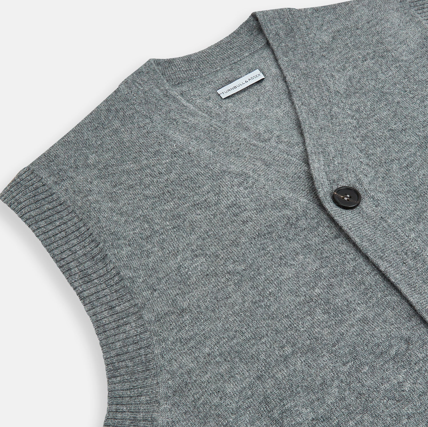 View 2 of product The Turnbull & Asser Ash Grey V-neck Sleeveless Cardigan features a button-up front, two front pockets, and ribbed edges, shown against a plain white background.