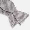 View 3 of product The Turnbull & Asser Grey and White Diamond Silk Bow Tie showcases a subtle diamond pattern, ideal for formalwear, and is elegantly displayed against a plain white background.