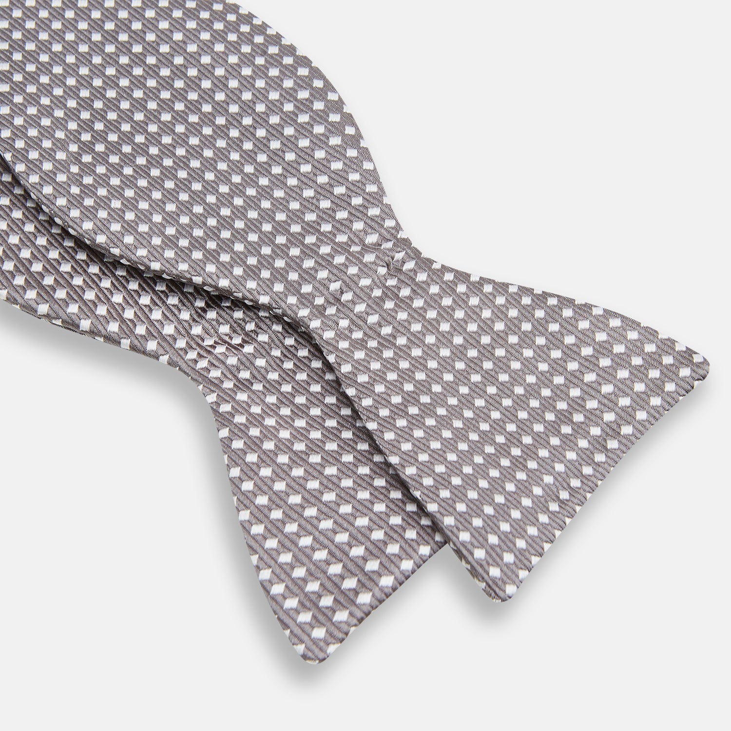 View 3 of product The Turnbull & Asser Grey and White Diamond Silk Bow Tie showcases a subtle diamond pattern, ideal for formalwear, and is elegantly displayed against a plain white background.