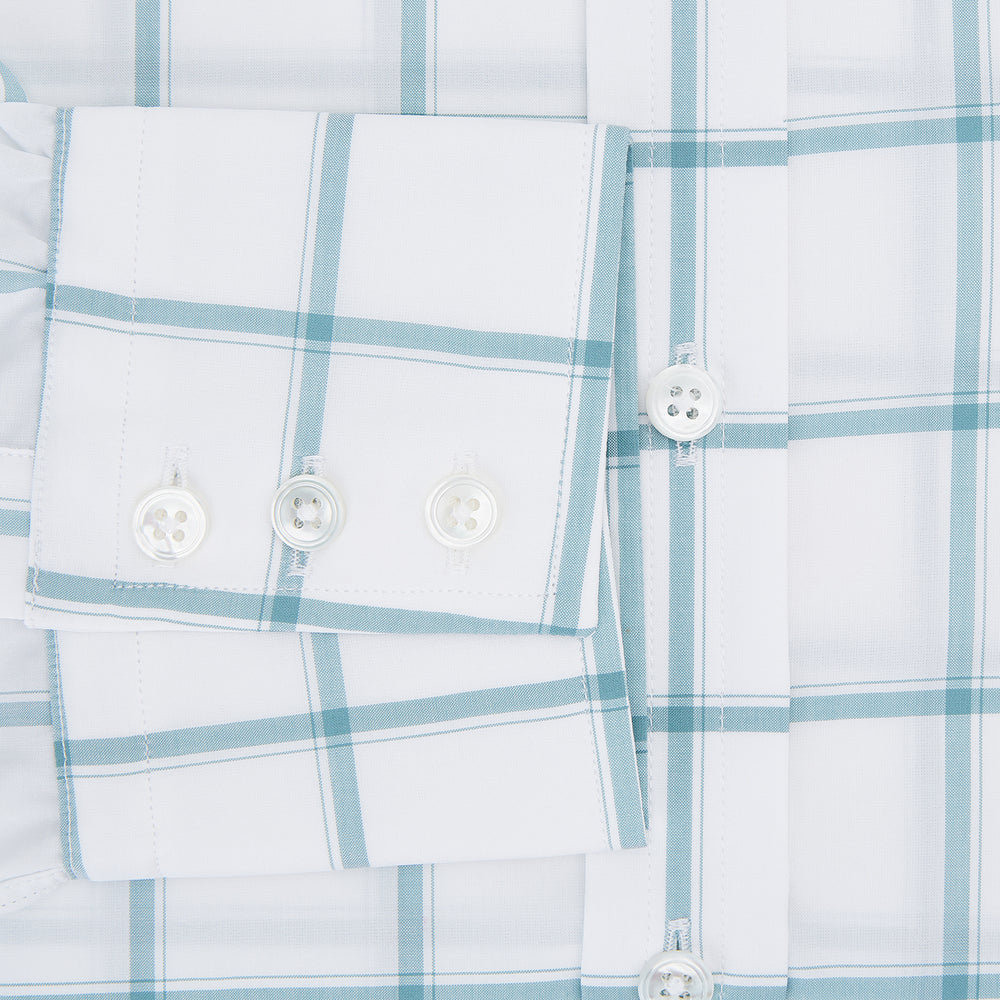 The Turnbull & Asser Sage Grid Check Mayfair Shirt is a white, long-sleeve shirt made from Italian cotton with a light blue and sage grid pattern, shown neatly laid flat on a plain, light background.