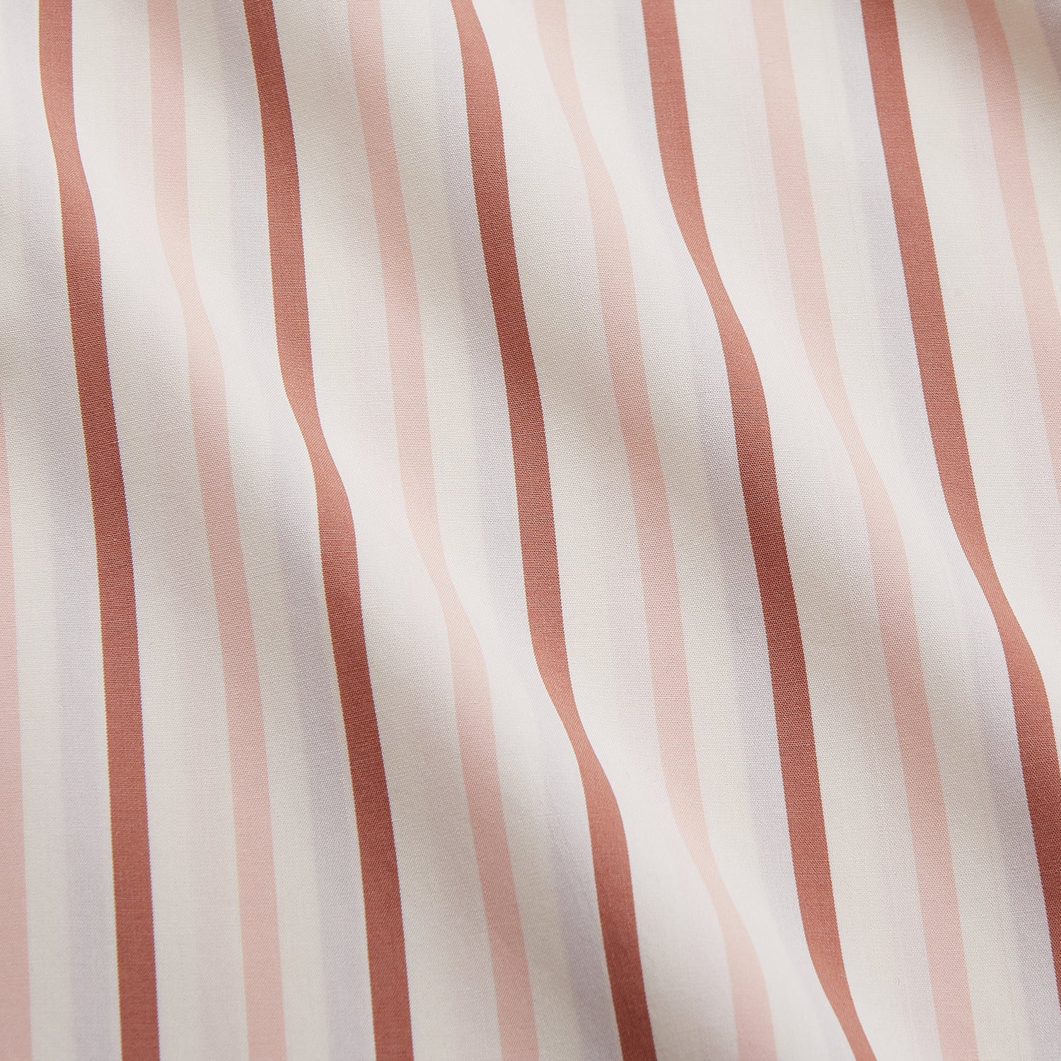 View 4 of product The Pink and Sandstone Stripe Cotton Regular Fit Mayfair Shirt by Turnbull & Asser features vertical pink and sandstone stripes on white, a T&A collar, wide cuffs, and a slightly curved hem for refined detail.