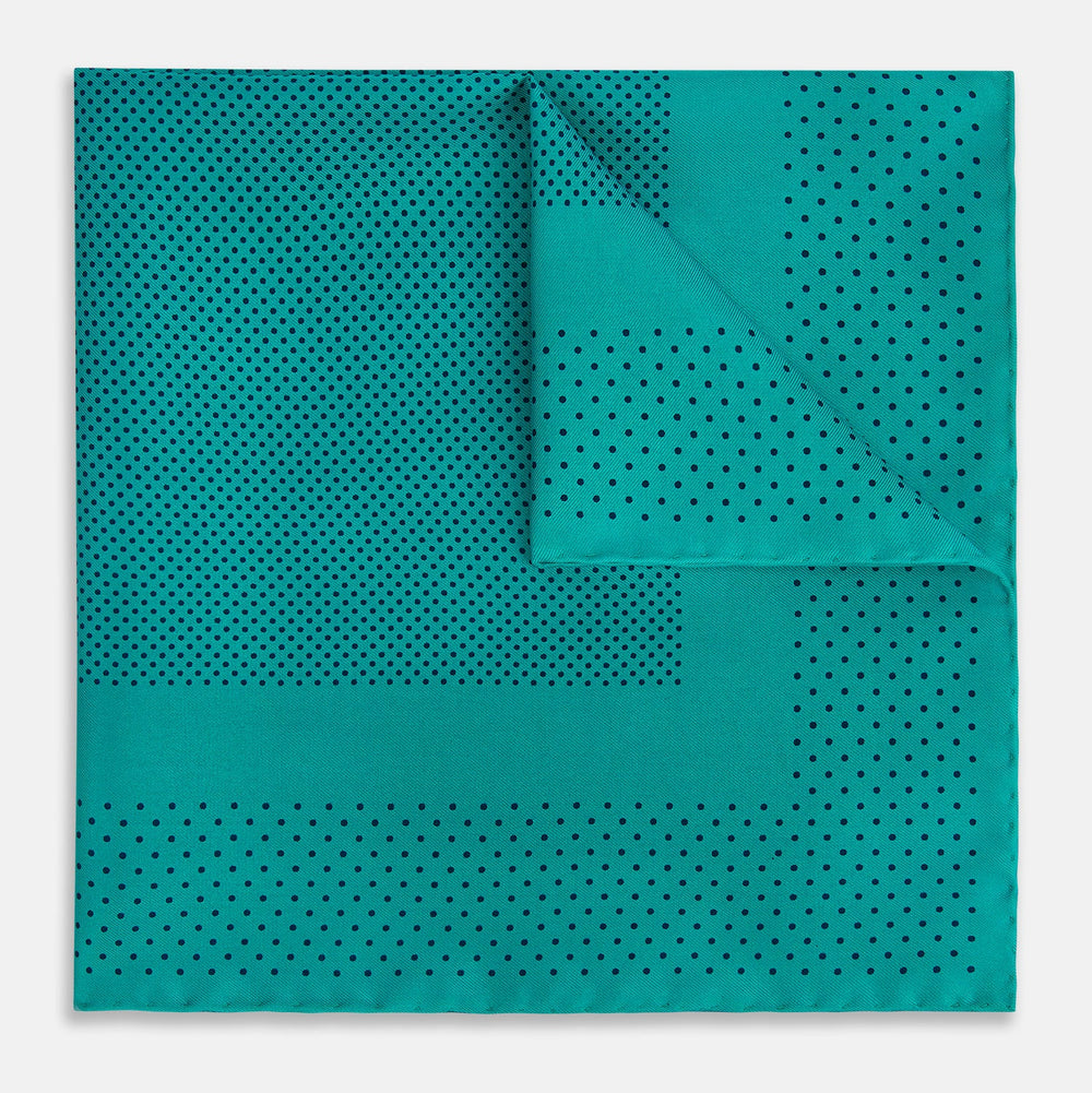 The Turnbull & Asser Petrol Green Dot Silk Pocket Square, made in England, features a border and small black polka dots, neatly folded to showcase both front and back sides.