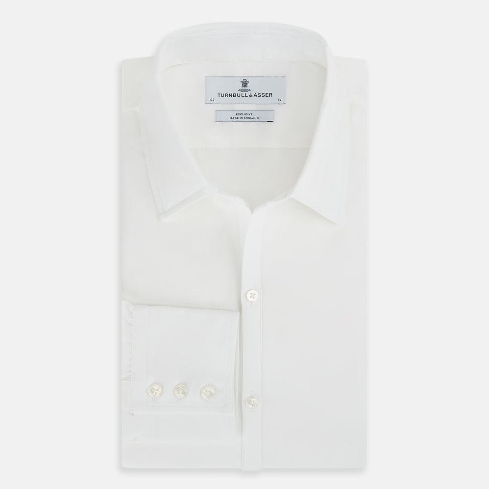 The Turnbull & Asser Plain White Windsor Shirt features a Turnbull open collar, 3-button cuffs, and relaxed fit—exemplifying British craftsmanship. Displayed on a white background.