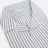 View 2 of product The Turnbull & Asser Purple Multi Stripe Quarzo Nightshirt features a collared, button-front design with a chest pocket and vertical white and light gray stripes, shown laid flat on a white background.