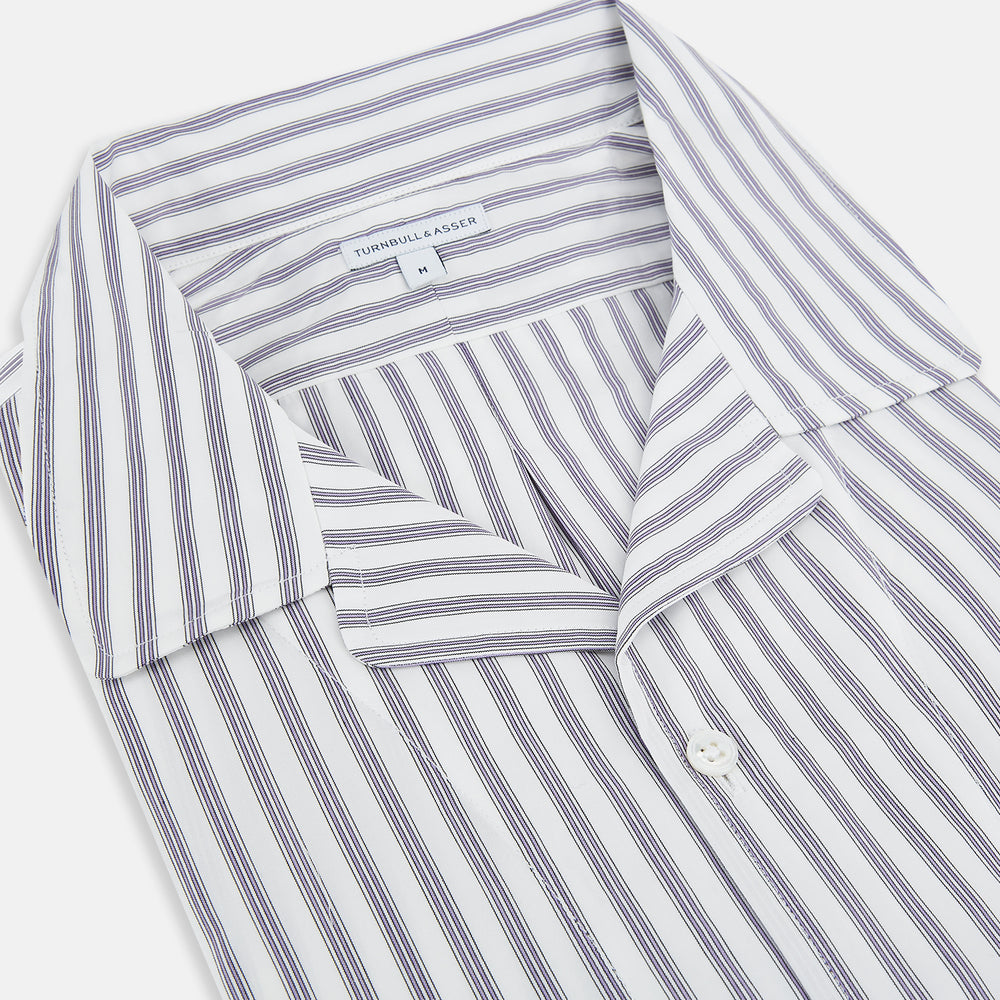 The Turnbull & Asser Purple Multi Stripe Quarzo Nightshirt features a collared, button-front design with a chest pocket and vertical white and light gray stripes, shown laid flat on a white background.