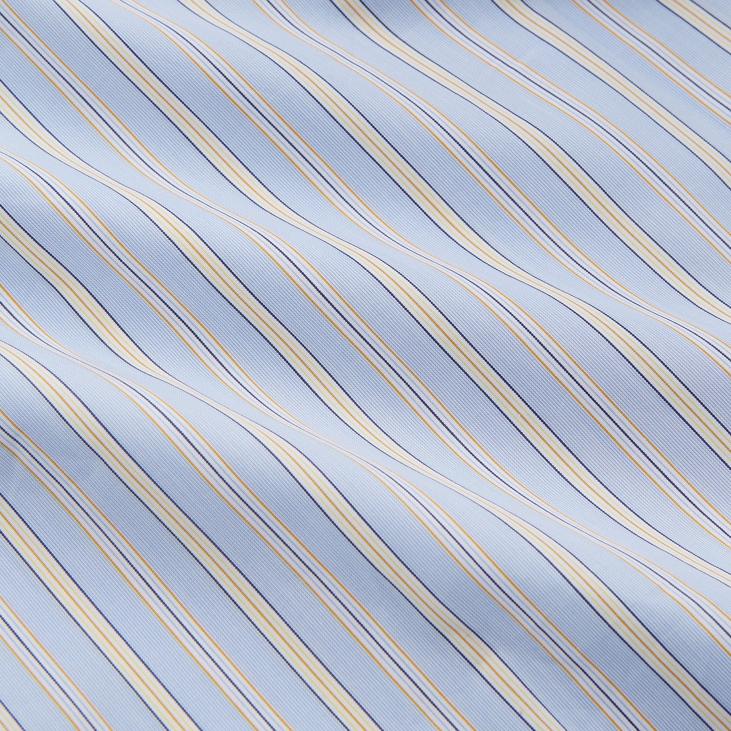 View 4 of product The Turnbull & Asser Blue and Yellow Stripe Poplin Cotton Nightshirt features light blue and yellow vertical stripes, long sleeves, a classic collar, single chest pocket, rounded hem, and is displayed flat on a white background.