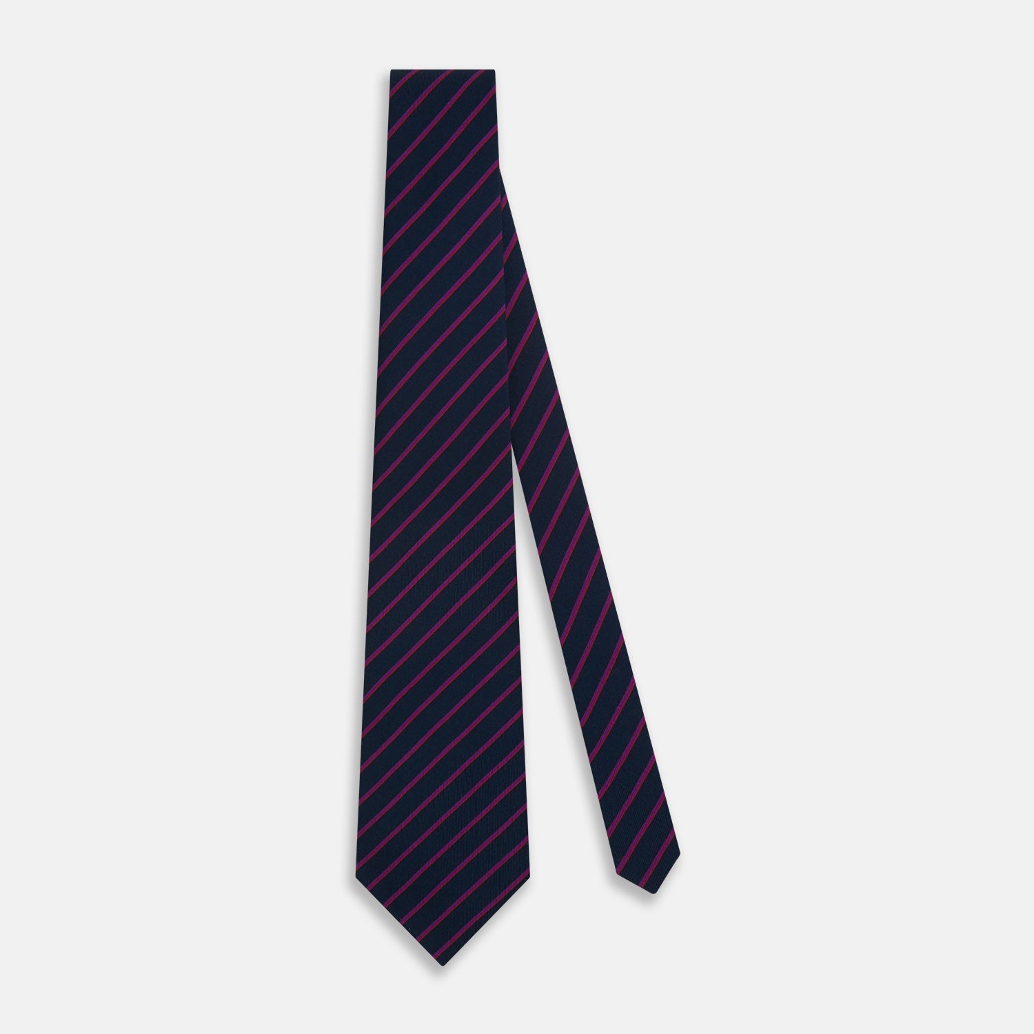 View 2 of product The Turnbull & Asser Navy and Purple Striped Blazer Silk Tie features British craftsmanship with diagonal magenta and purple stripes, displayed neatly rolled on a white background.