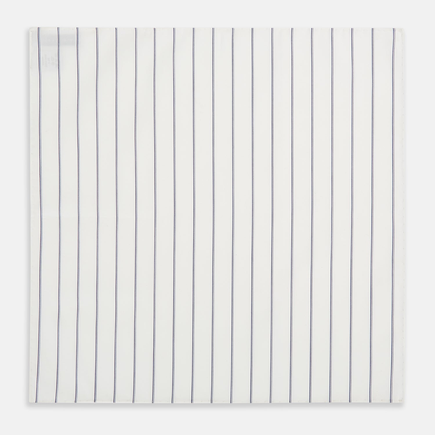 View 3 of product The Dark Navy Double-Pinstripe Hand-Rolled Handkerchief by Turnbull & Asser features white fabric with evenly spaced thin dark navy stripes and refined hand-rolled edges.