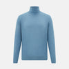 View 1 of product Turnbull & Asser's Pale Blue Fine Merino High Neck Jumper is shown on a plain white background, featuring a simple, classic design with long sleeves and no visible patterns or embellishments.
