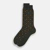 View 2 of product A single Turnbull & Asser Forest Green Patterned Mid-Length Sock with orange polka dots is displayed upright against a plain white background.