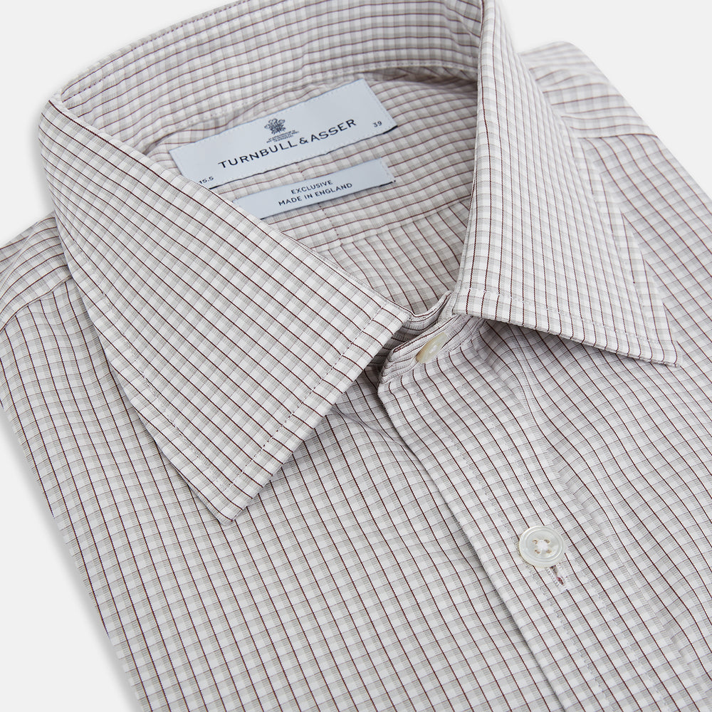 The Turnbull & Asser Grey Micro Shadow Check Mayfair Shirt is crafted from premium Italian cotton with long sleeves, a collar, and buttoned cuffs, shown folded flat against a white background.